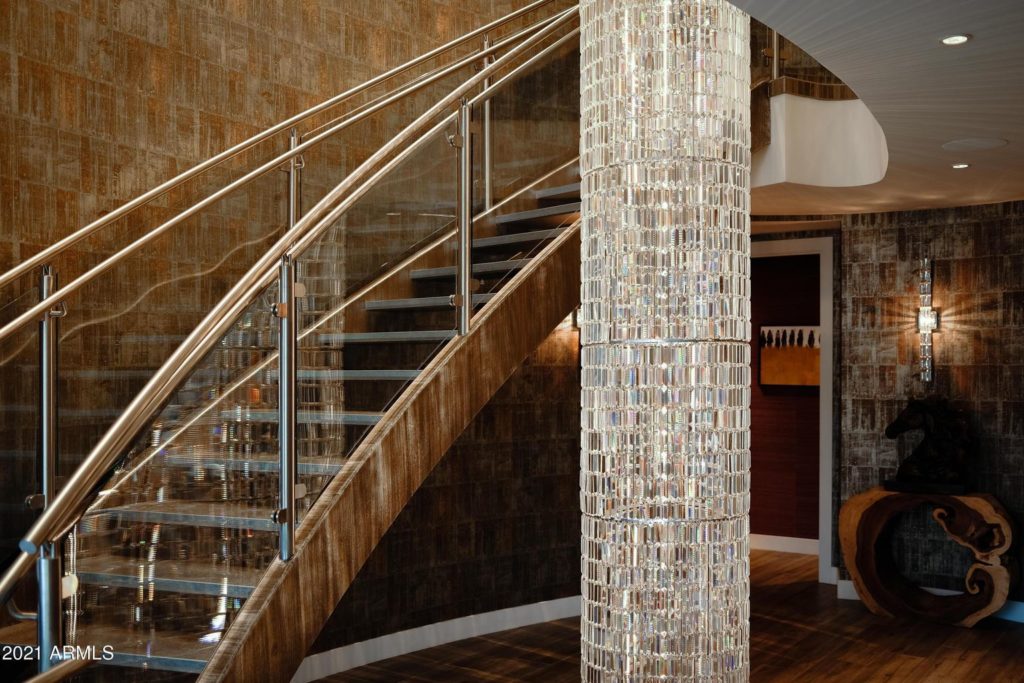 floor to ceiling chandelier and curved staircase